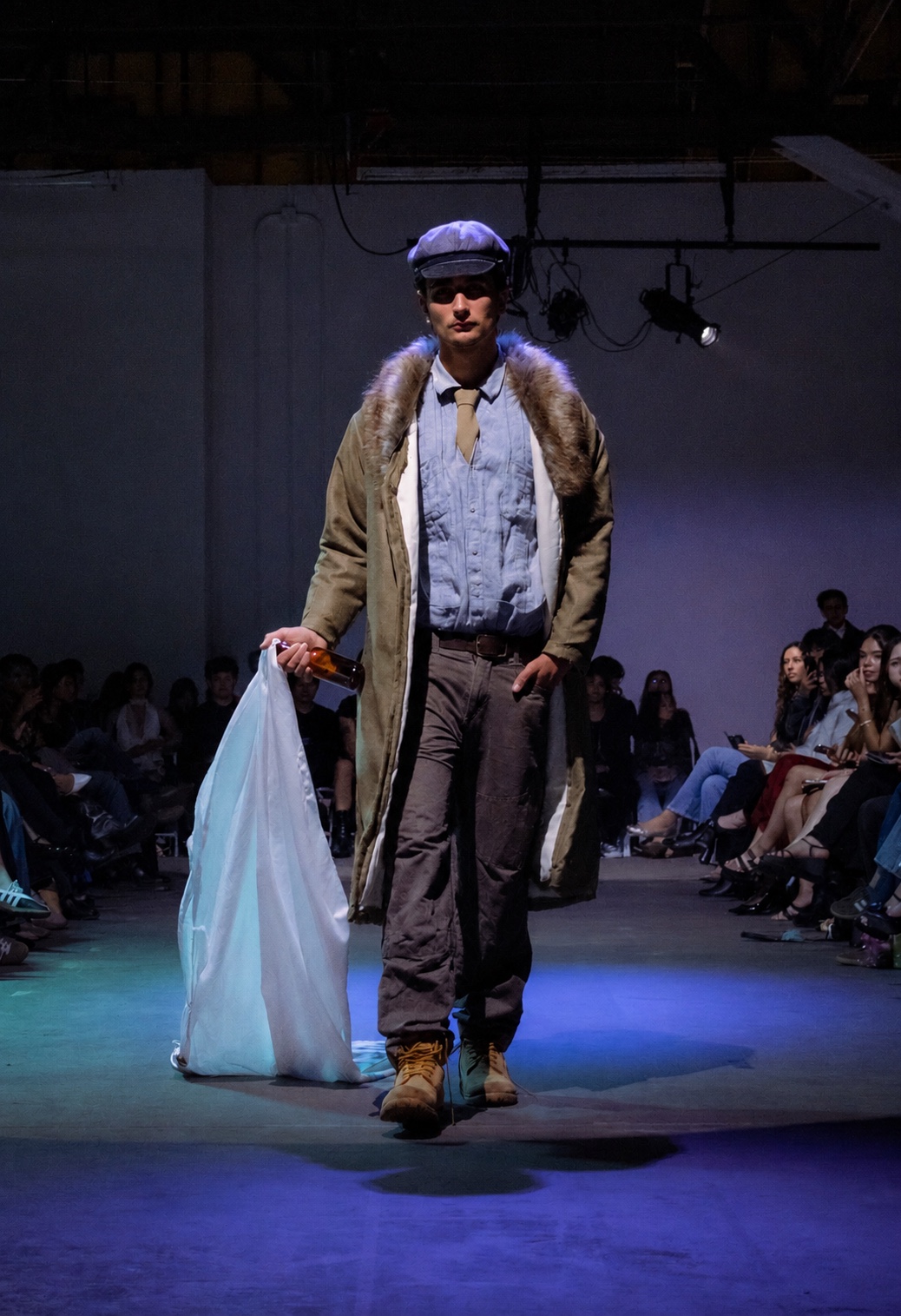 Runway — fur-collared parka under warehouse light