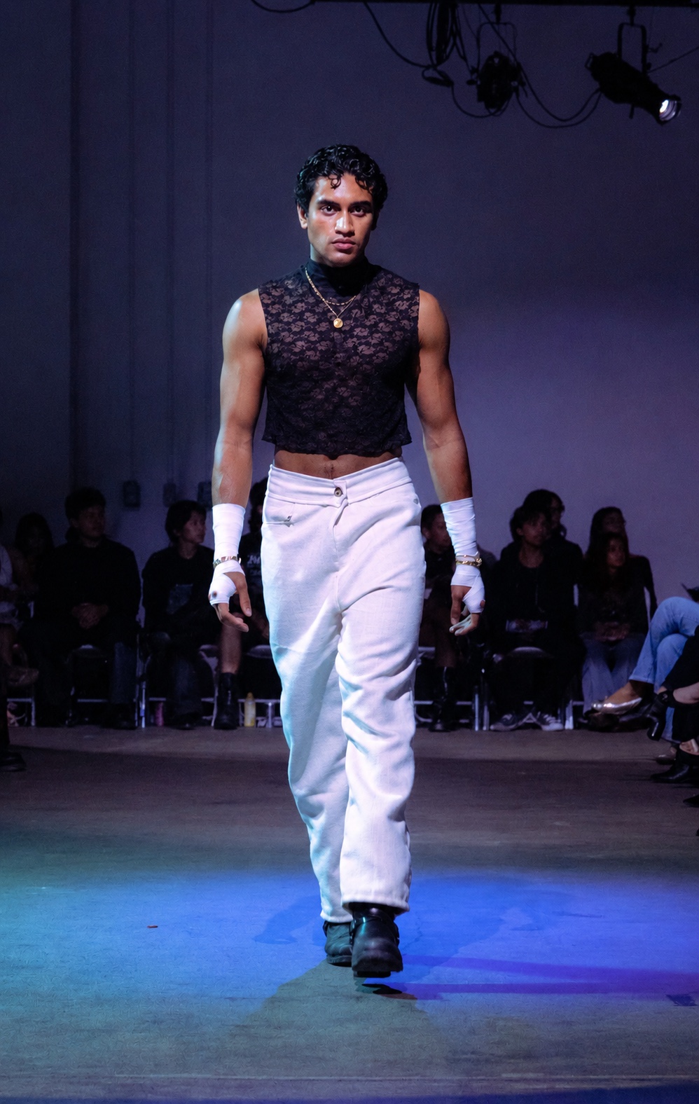 Runway — black crochet vest and white trousers