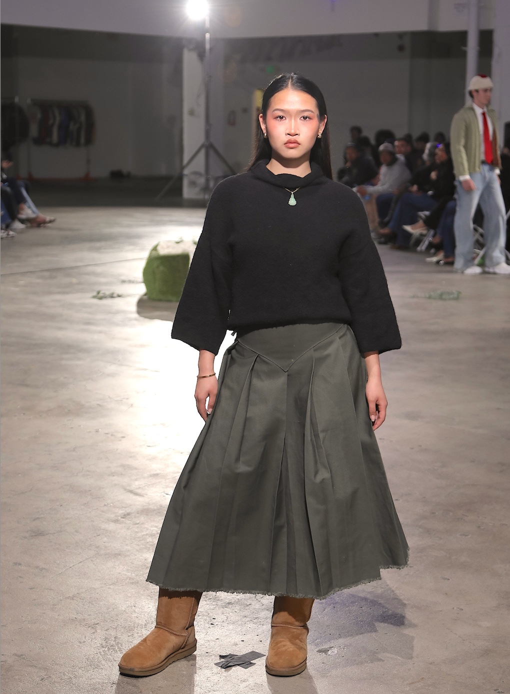 Daylight runway — black knit and olive pleated skirt